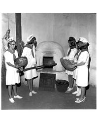 Cinnabar and Rolling Hills 4-H members placing bread in the oven at the Old Adobe Fiesta, Petaluma, California, 1967