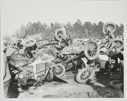 Large pile of wrecked racing cars