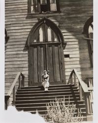 Mary McGregor sitting on the steps of St. Paul's Episcopal Church in Virginia City, Nevada, 1941