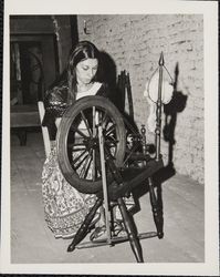 Linda Margarain performs many chores at the Petaluma Adobe, including spinning, grinding corn, candlemaking, baking, etc, Petaluma, California, 1977