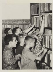 Boys searching book shelves of Petaluma Carnegie Library, 20 Fourth Street, Petaluma, California, October 2, 1962