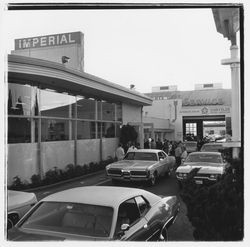 New cars and attendees at the Zumwalt Chrysler-Plymouth Center Open House outside the showroom, Santa Rosa, California, 1971