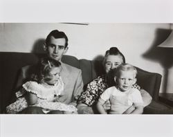 Bill and Janet McGregor sitting on a couch and holding Bonnie and Bill Alwes in their laps, Santa Rosa, California, about 1949