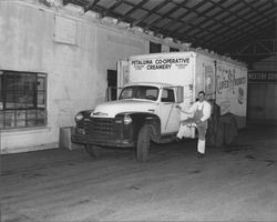 Driver getting into a Petaluma Co-operative Creamery truck, Petaluma, California, 1955