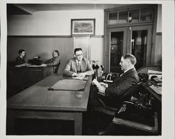 Ernest Finley meeting with a member of his staff