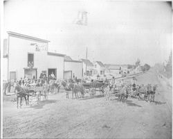 Men and wagons in front of B.F. Cox Express Stable