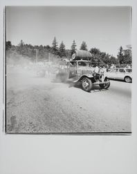 Barrels being rolled off a truck at the Guerneville rodeo, Guerneville, California, 1978