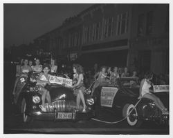 Two cars from Santa Rosa Junior Chamber of Commerce in the 1947 Admissions Day Parade in Santa Rosa, California containing girls in bathing suits--The "Live Wires."