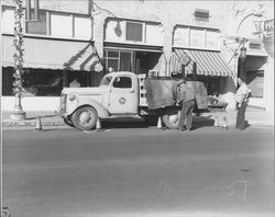 City crews installing Christmas decorations along lamp posts, Petaluma, California, 1945