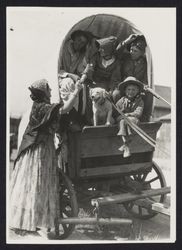 Family in a covered wagon at the centennial of the founding of Sonoma Mission