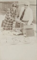 Alice Wells and George S. Rohe placing items in the time capsule at the Rohnert Park Public Library