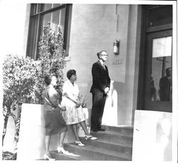 Three people standing on steps of Sebastopol Library