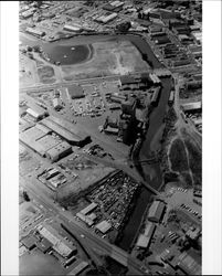 Aerial view of Petaluma showing the Turning Basin, Dairyman's Feed, and businesses along the Petaluma River between Washington Street Bridge and Lakeville Street