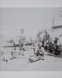 Two farm workers at the water pump on the Akers ranch in Schellville, California, photographed between 1890 and 1900