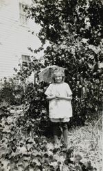 Dorothy Donogh standing with an umbrella, Petaluma, California, about 1925