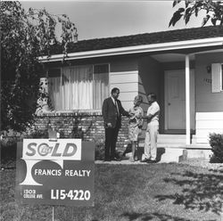 Couple receiving keys to home sold by Francis Realty