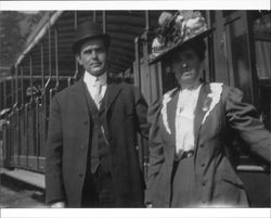 Walter S. Neil standing with an unidentified woman in front of a railroad car - possibly the Mount Tamalpais Scenic Railway, Mill Valley, California, about 1908