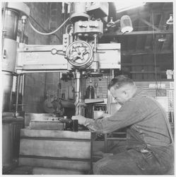 Drill press operator working in an unidentified machine shop, 1950s or 1960s