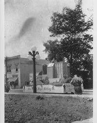 Floats being driven down East Washington Street near the intersection of Copeland Street, Petaluma, California, about 1920