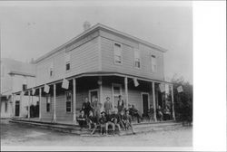 People on porch of Commerical Hotel