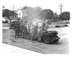 Children surrounding a jeep in St. Vincent's schoolyard, Petaluma, California, 1943