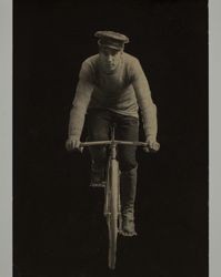 Portrait of Henry Robert Jenkins riding a bicycle, photographed between 1900 and 1910