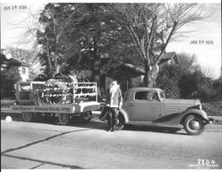 Gordon Olson posing as Santa standing next to his "sleigh" in front the Tomasini home at 625 D Street, Petaluma, California in 1936