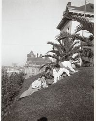 Female members of the McNear family frolic on the grass at the Hamlin School, San Francisco, California, about 1910