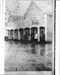 Men gathered on the porch of O.M. LeFebvre's hotel, Bloomfield, California, about 1875