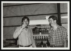 Chris Biaggi samples a glass of Seghesio wine--Ted Seghesio looks on