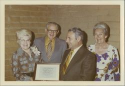 Helen Putnam presenting a plaque to R. Benton, fire chief, Petaluma, California, 1972