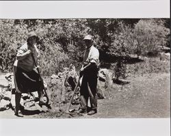 Two unidentified people excavating petrified wood, Calistoga, California, 1934