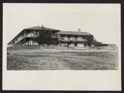 Woman standing on balcony of Old Adobe