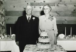 George and Emily Blank pose behind a cake for a photograph during their golden wedding anniversary celebration at the Green Mill Inn on November 1, 1949