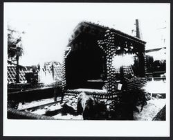 Structure made from apples with bear in foreground