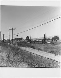 Dredger at work south of railroad bridge and Highway 101 overpass, Petaluma, California, 1973