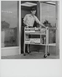 Don Gass pushing a book truck at the Jail Division