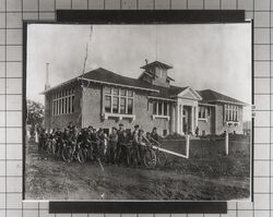 Group of boys with their bicycles in front of Windsor School