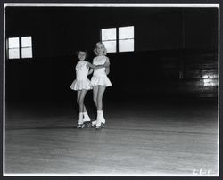 Gale Anderson and Margaret Shultz roller skating, Santa Rosa, California, 1957