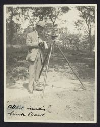 Surveyor Frank M. Bond with a transit