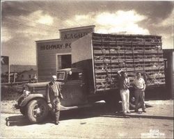 Angelo Agius, Sr. standing with his sons John and Angelo, Jr. in front of a truck loaded with chickens, Petaluma, California, about 1939