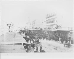 Acrobat walks across a high wire on Main Street, Petaluma, California, about 1900