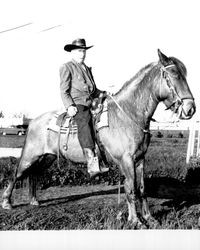 Dan Riordan on horseback at the rodeo grounds, Petaluma, California, 1964