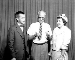 Dr. Charles Peck and Frank Connor with a woman on crutches, Santa Rosa, California, 1962