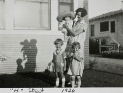 Edith Cochrane with her children, Ray, Marjorie and Dorothy, standing in front of her house, 415 H Street, Petaluma, California, 1926