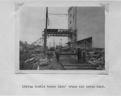 Laying double track through the truck and train shed of the Poultry Producers of Central California feed mill, Petaluma, California, 1938