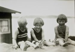 Ray, Marjorie and Dorothy Raymond sitting in the sand, about 1927