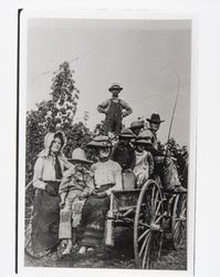 Family of hop pickers arriving at the field by wagon