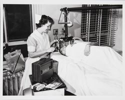 Nurse takes a patient's temperature