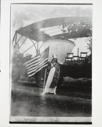 Erlene Radcliff in front of a float depicting a giant basket filled with prunes